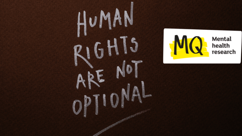 On a black slate surface, the words 'Human rights are not optional' are written in chalk, in capitals and underlined.